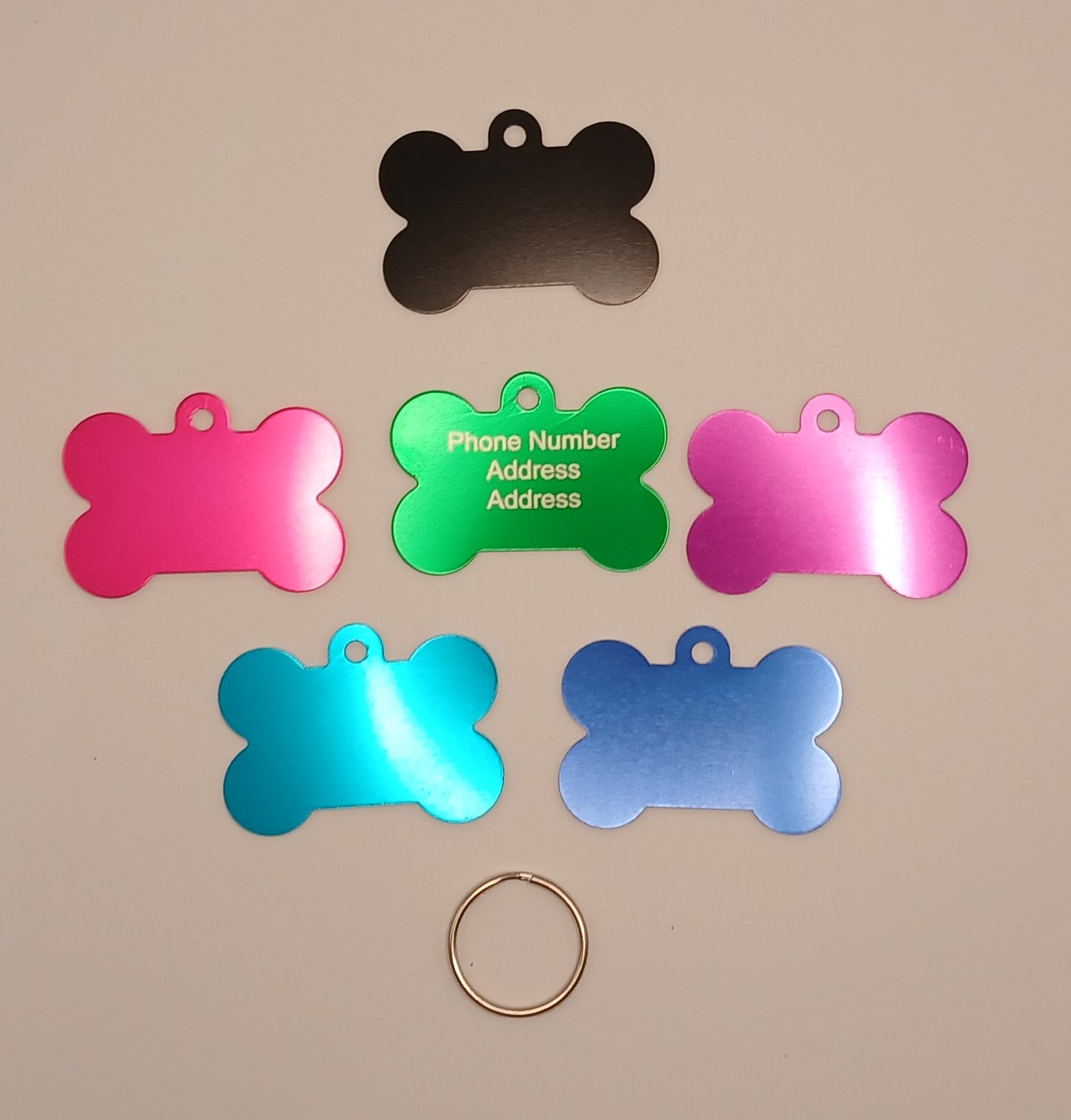 Dog ID Tags. Bone Shaped, with Steel Ring Loop. Variety of Colours. Suits Medium to Larger dogs.