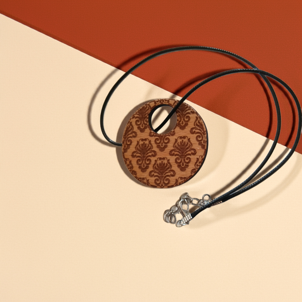 Detailed Wood Flower Pattern Engraved Pendant with waxed necklace. Pendant measures 50mm diameter