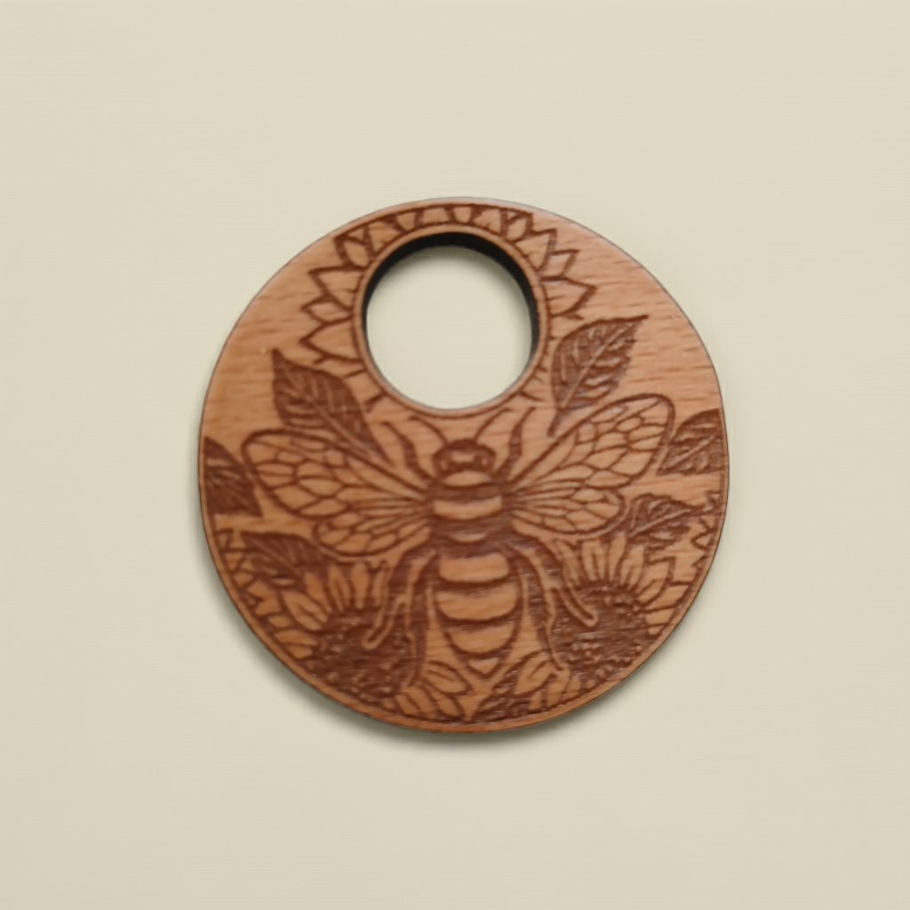 Wood Pendant with a Bee and Floral engraving, with waxed necklace. Pendant measures 50mm diameter