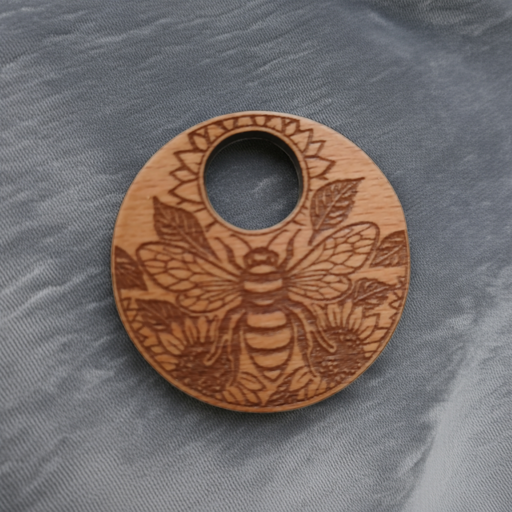 Wood Pendant with a Bee and Floral engraving, with waxed necklace. Pendant measures 50mm diameter
