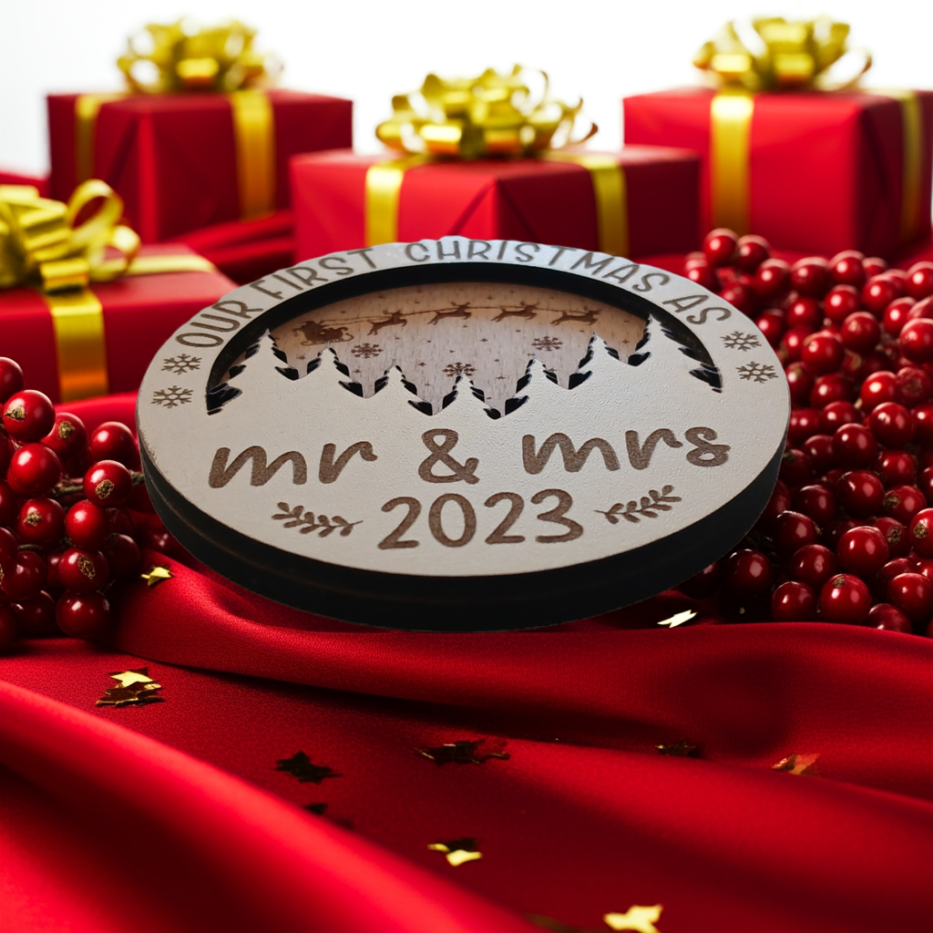 x2 Our First Christmas, Wood Christmas Tree Bauble. 70mm diameter, 6mm thick. Personalise with year and title of choice e.g. Mr & Mrs